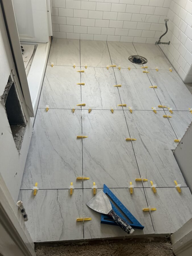 Bathroom floor tile layout with clean alignment and prep work