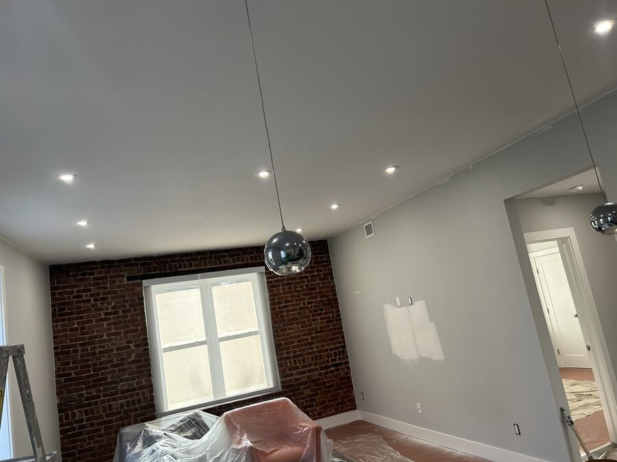 Interior room with exposed brick, gray walls, and protected work area