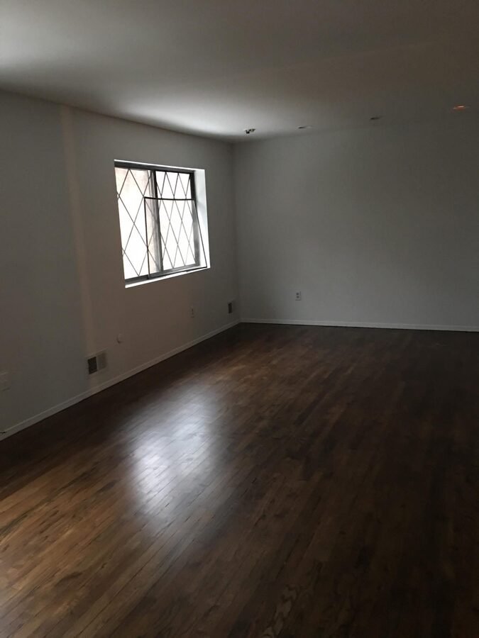 Finished interior room with dark floor, trim, and bright wall finish