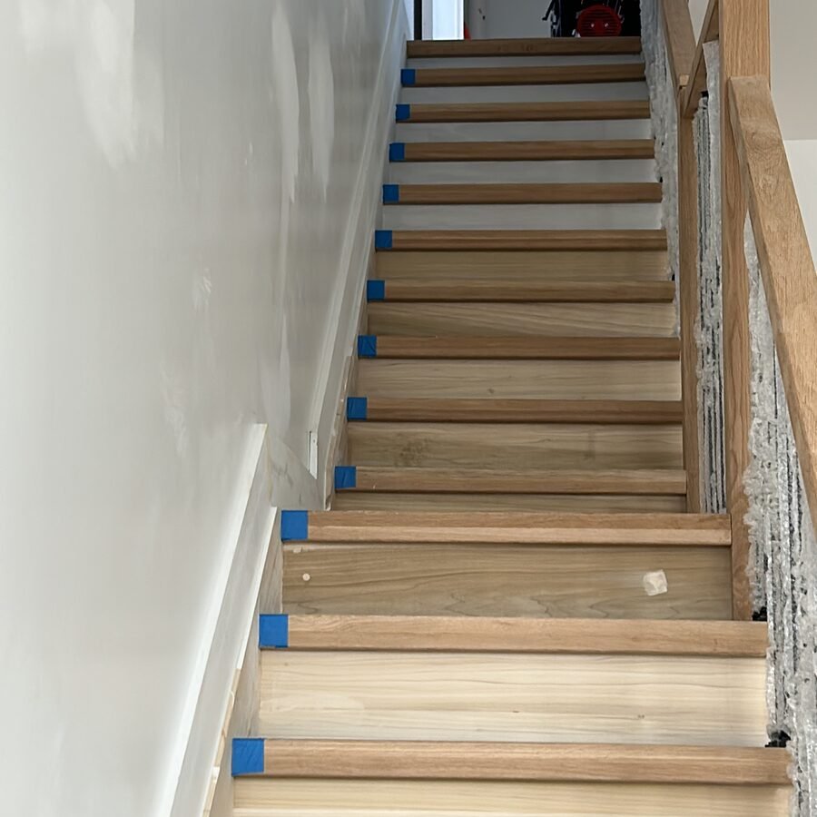 Interior staircase with new treads protected by blue tape