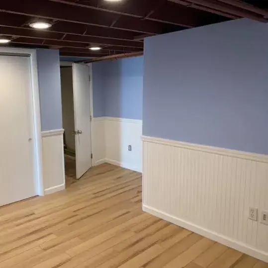 Light wood flooring with white trim and beadboard detail